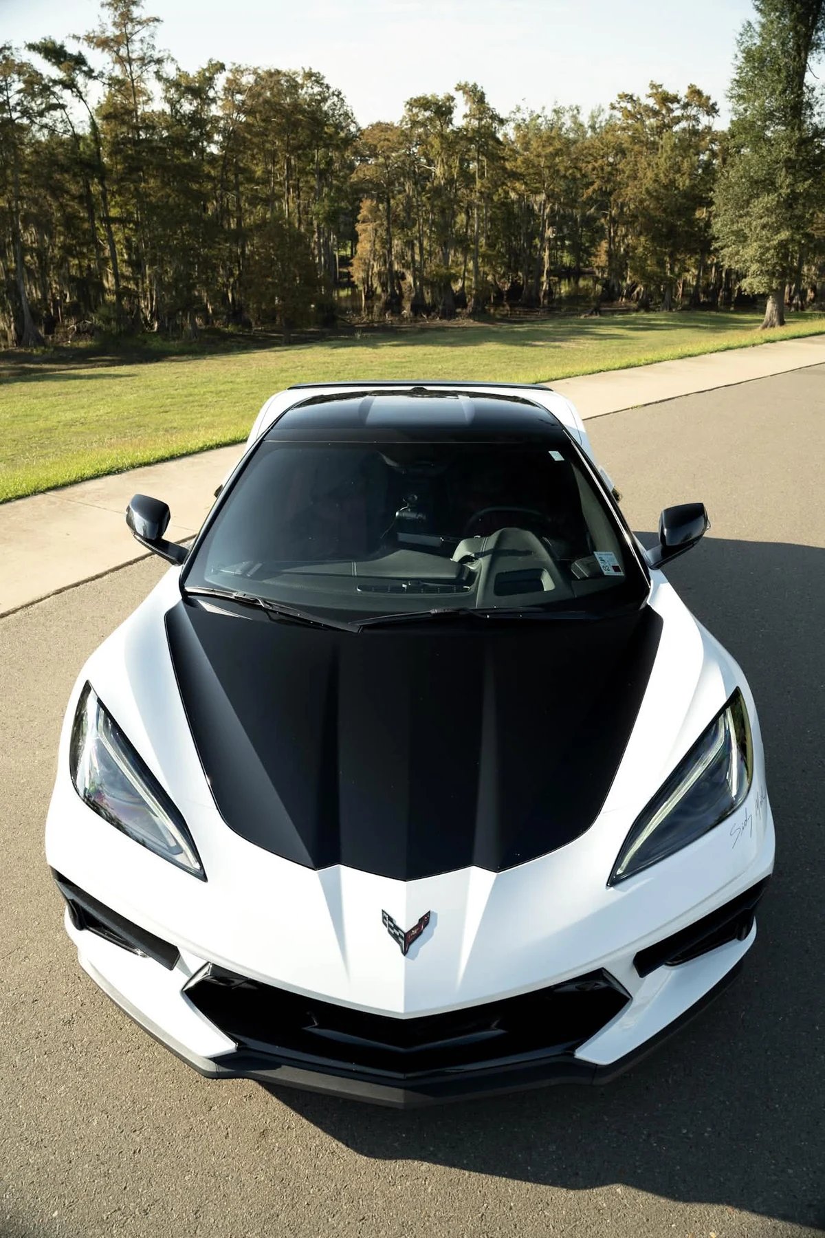 White Corvette C8 with black hood wrap