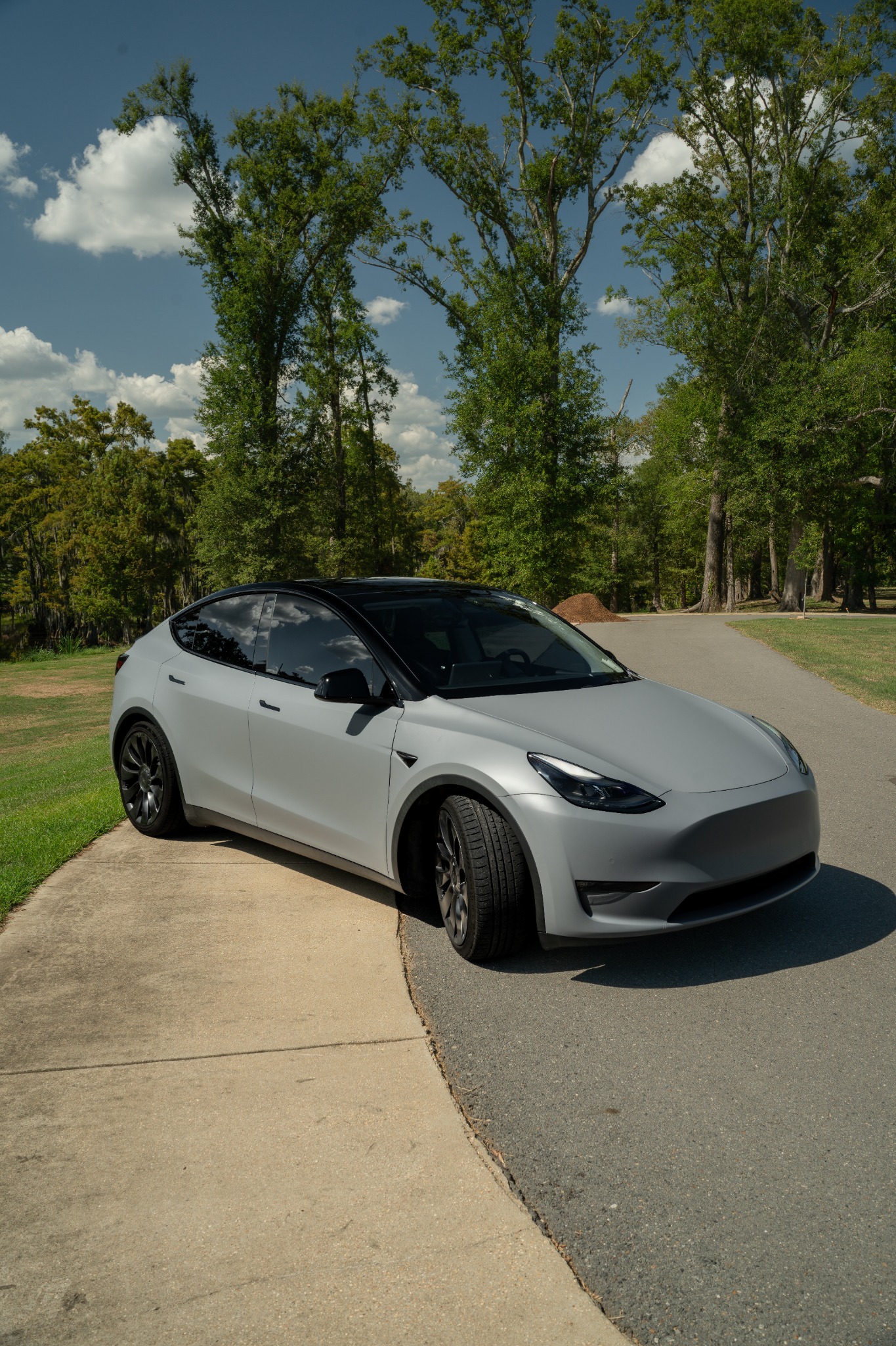Matte gray Tesla Model Y with gloss black roof and trim