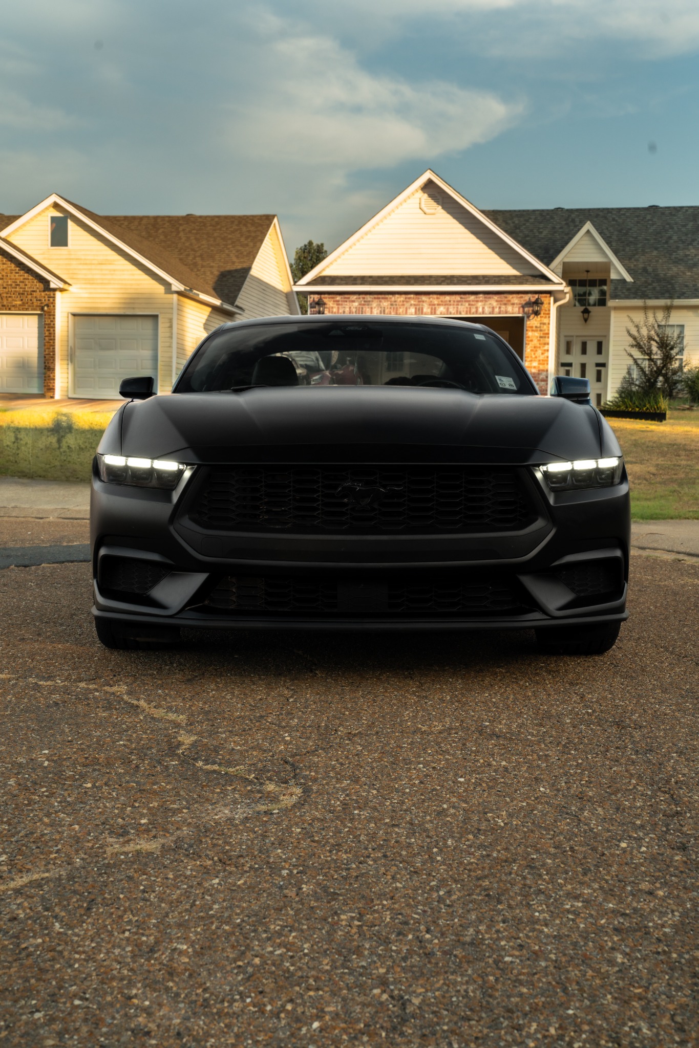 Front view of satin black Ford Mustang