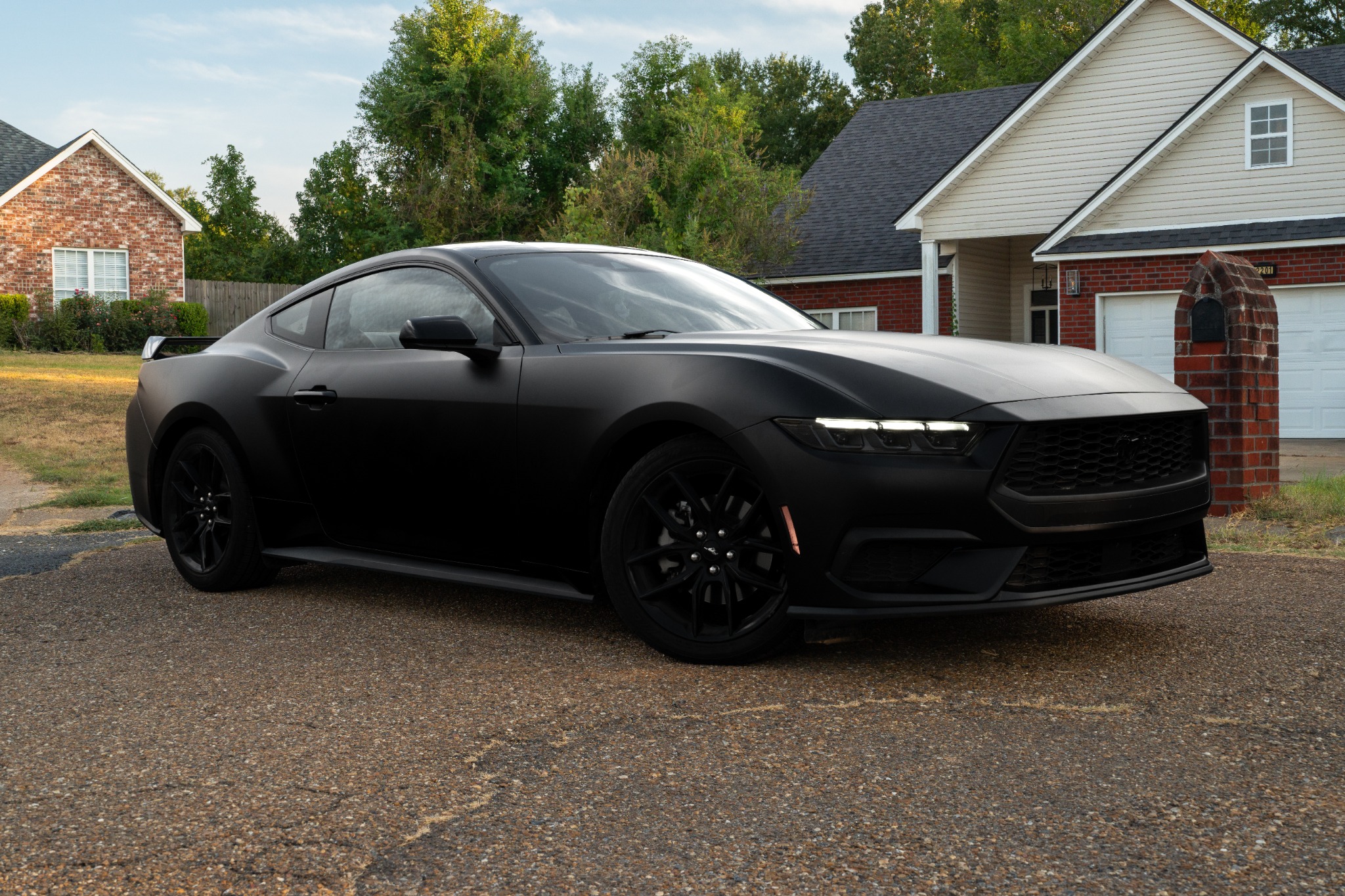 Satin black Ford Mustang photographed after vinyl work