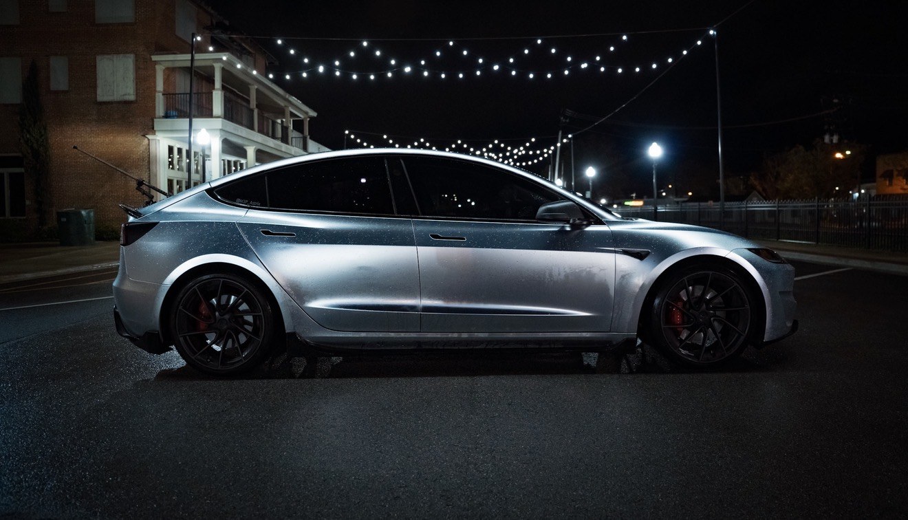 Silver Tesla Model 3 photographed at night