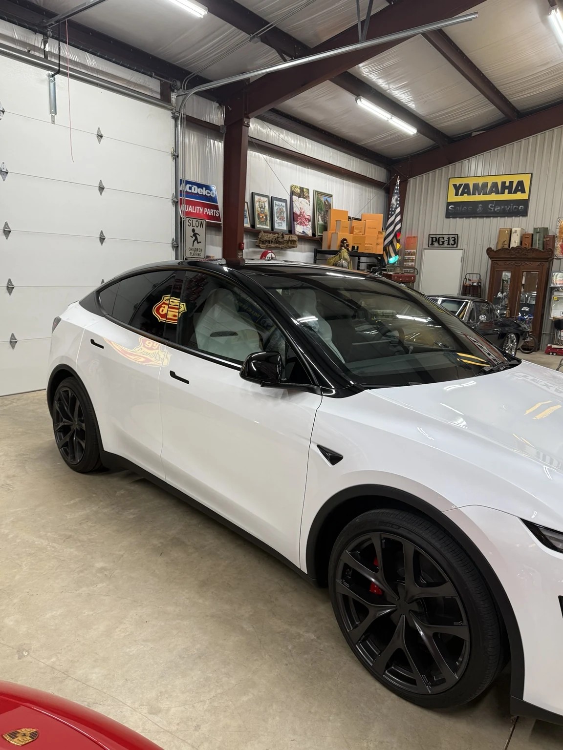 White Tesla Model Y with a black pillar delete