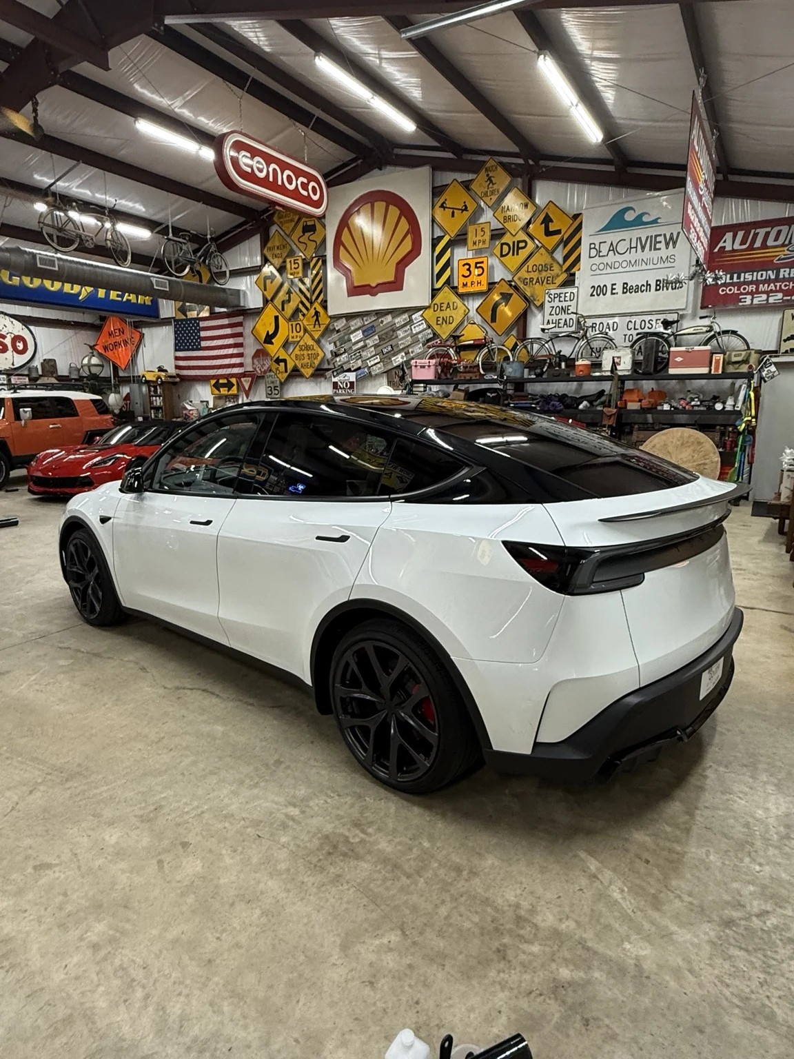 White Tesla Model Y rear view after pillar delete